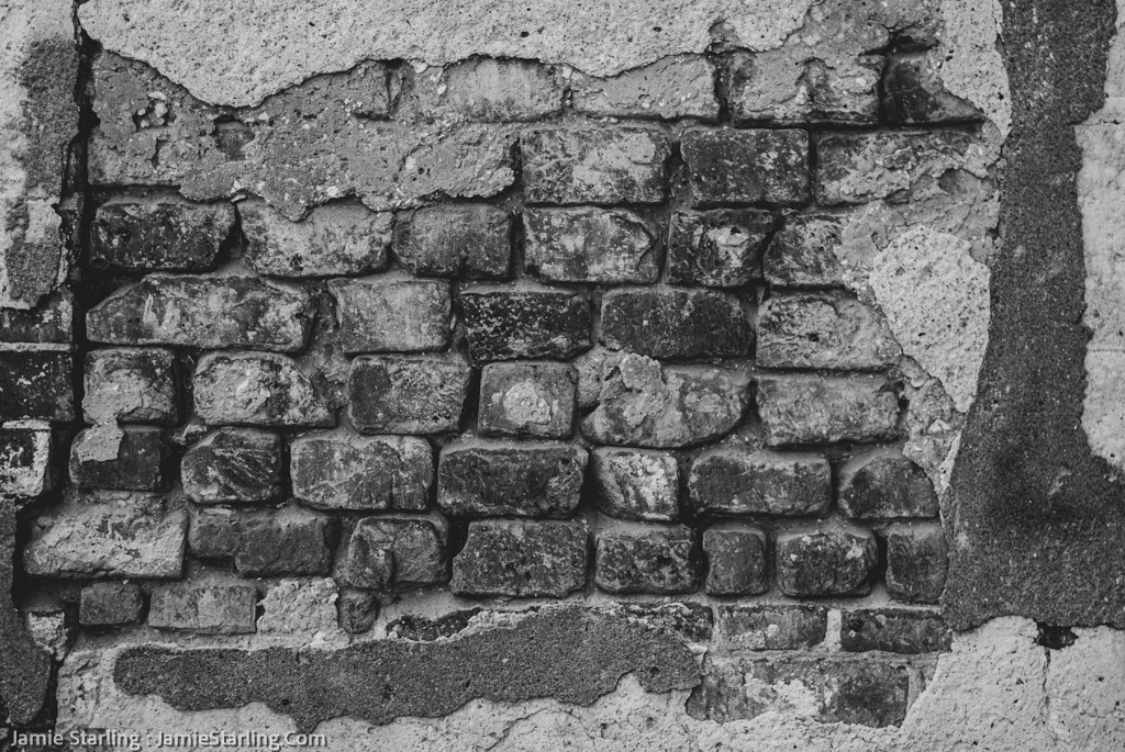 An evocative image capturing the intricate details of a weathered brick wall, each crack and flaw telling a story of survival and strength. The image symbolizes the journey of embracing imperfections as markers of resilience and personal growth.