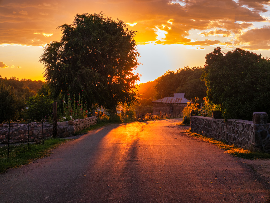 A captivating view of a road winding through a countryside scene during sunset, reminding us of the continuous cycle of challenges and renewal.