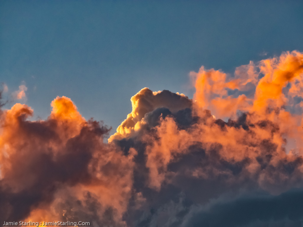 An captivating image of a sunset with clouds glowing in orange, representing the beauty and diversity of individual thoughts and feelings against the vast canvas of the sky.