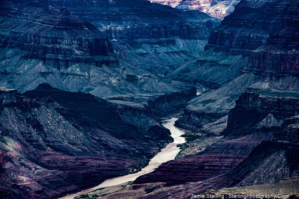 The Grand Canyon in monochrome, with the Colorado River winding through it, serves as an inspiring visual parallel to the peaceful and persistent flow of seeking serenity in our lives.