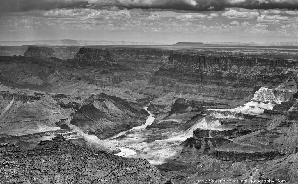 A striking black and white image of the Grand Canyon, representing the metaphorical journey of self-discovery and the embrace of life's full spectrum, as vast and profound as the canyon itself.
