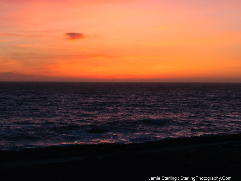 A captivating sunset over the ocean with vibrant colors reflecting on the water, symbolizing the beauty and wisdom found in life's transitions.