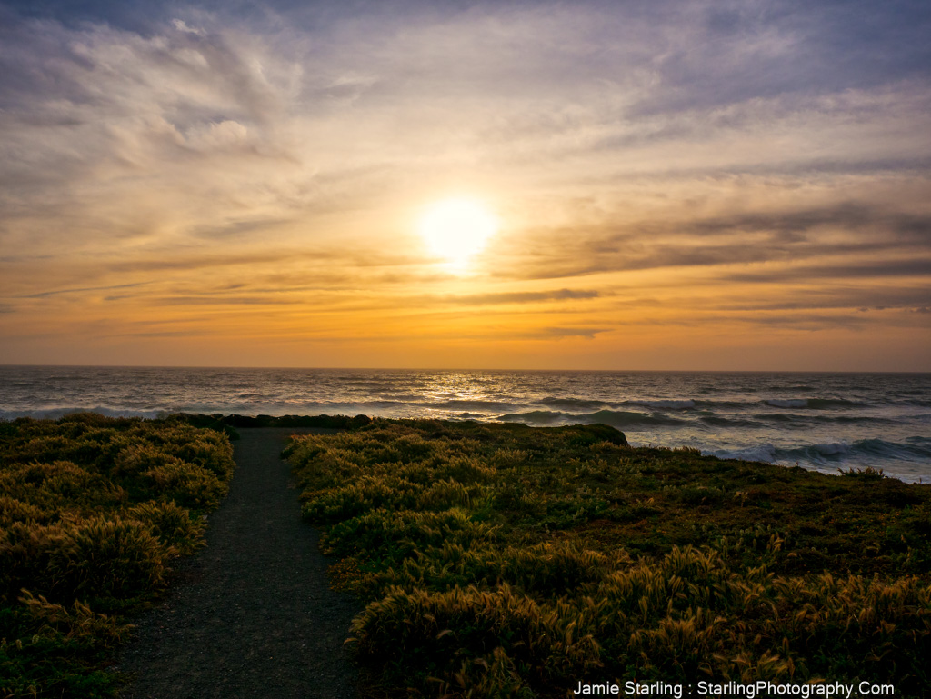 A path along the coast at sunset, representing the journey towards truth, illuminated by the golden light of the setting sun, inviting a connection to inner wisdom and authenticity.