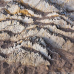 Close-up of a layered rock formation with intricate patterns and textures, symbolizing the layers of personal growth and transformation.
