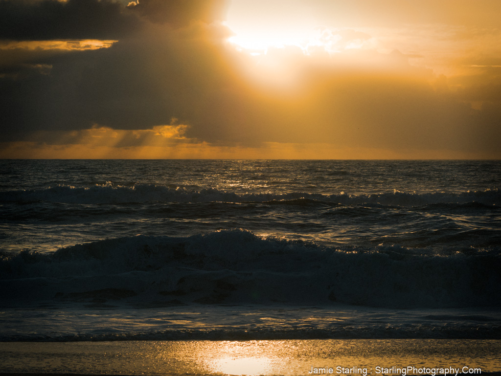 A peaceful coastal scene at sunset, where sunlight meets the ocean and shadows create a harmonious balance, inviting a moment of reflection and calm.