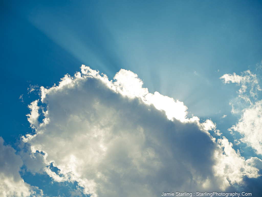 Sunlight breaking through clouds, symbolizing the journey of awakening from societal illusions and finding personal freedom.