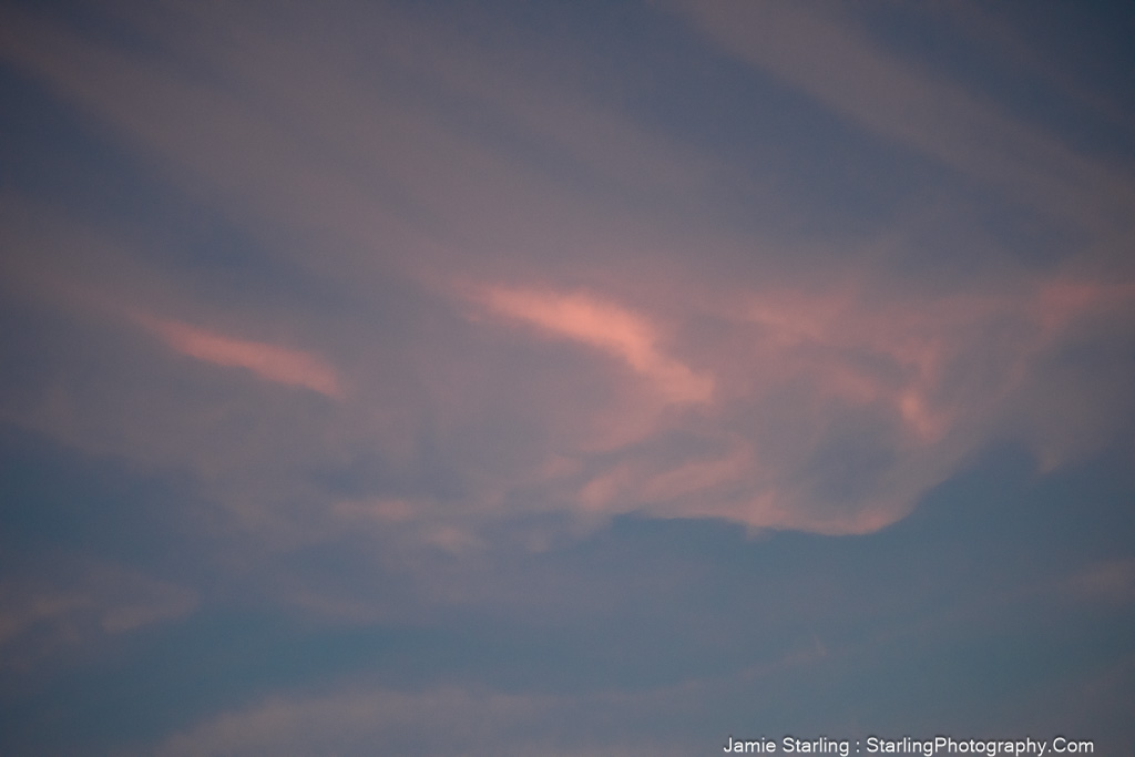 Soft clouds drifting in the sky, symbolizing the beauty of letting go and moving with life's flow.