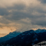 Mountain peaks under layered clouds, showcasing the subtle beauty that emerges when we take time to notice.