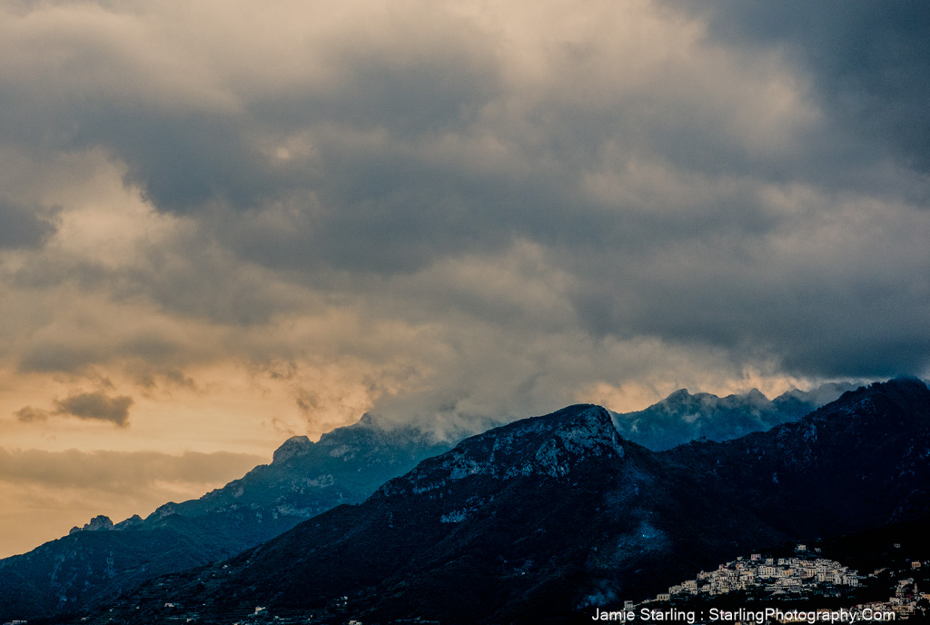 Mountain peaks under layered clouds, showcasing the subtle beauty that emerges when we take time to notice.